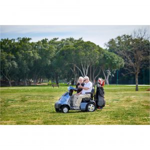 Lifestyle Image Side View of Blue S4 Afiscooter Dual Seat Mobility Scooter with Golf Bag Holder
