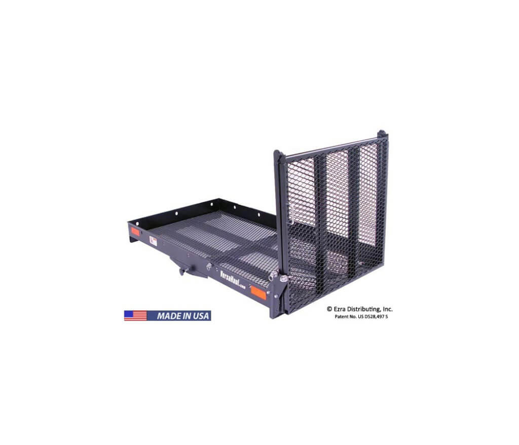 A black hitch-mounted cargo carrier with a folding ramp. The carrier has a mesh surface and raised sides for securing items. It is designed for attaching to the back of vehicles to transport wheelchairs, scooters, or other heavy equipment.