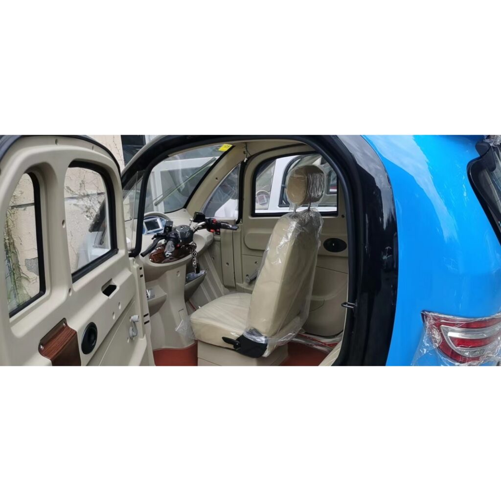 Open door view of a GIO Golf mobility scooter with a beige interior, showing a wrapped seat and steering controls.