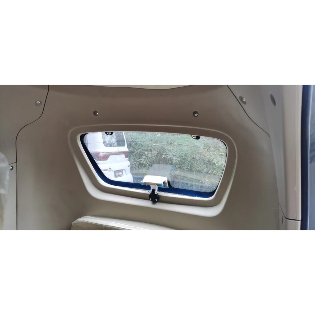 View through the rear window of a GIO Golf mobility scooter, showing a beige interior frame.