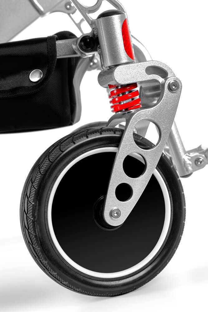 Porto Mobility Ranger Discovery XL folding power wheelchair, front caster with red spring close up