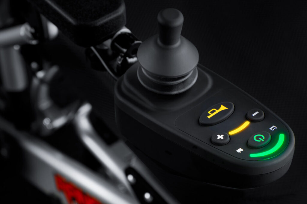 Porto Mobility Ranger Quattro XL folding power wheelchair, joystick control with lit buttons close up